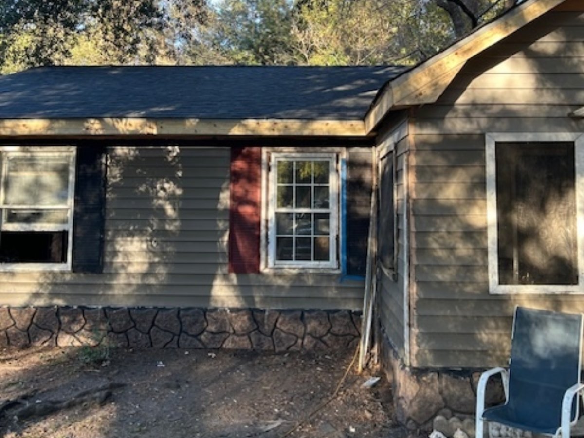 Team assessing home repair needs during a client visit